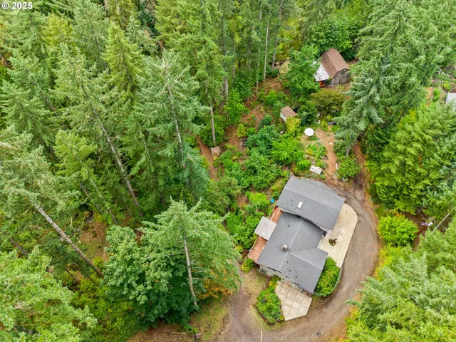 a kitchen with stainless steel appliances a sink a stove a refrigerator cabinets and a window