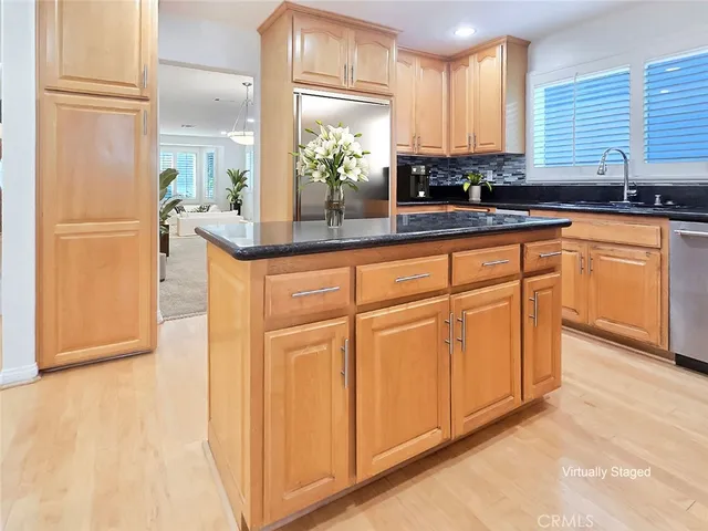 a kitchen with granite countertop a sink and cabinets
