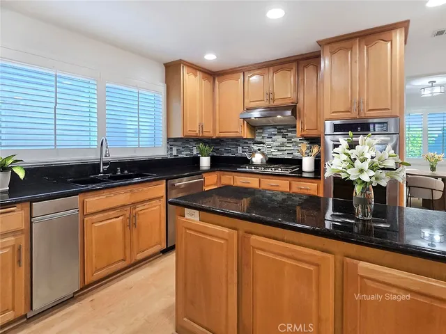 a kitchen with granite countertop cabinets sink and a granite counter top