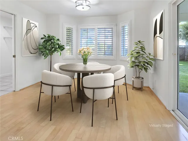 a view of a dining room with furniture and a potted plant