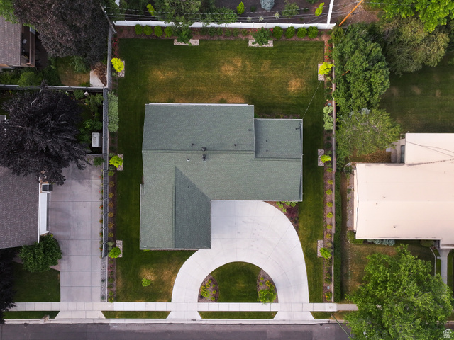 1774 Country Club Drive Logan, UT 84321 - Photo 23 of 28 L-shaped residential structure with a green shingle roof, a curved concrete driveway, and a front lawn bordered by landscaping