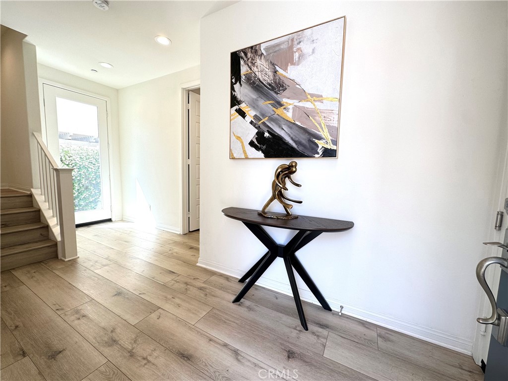 35 Hideaway Loop Mission Viejo, CA 92692 - Photo 7 of 24 a view of a hallway with wooden floor and dining room