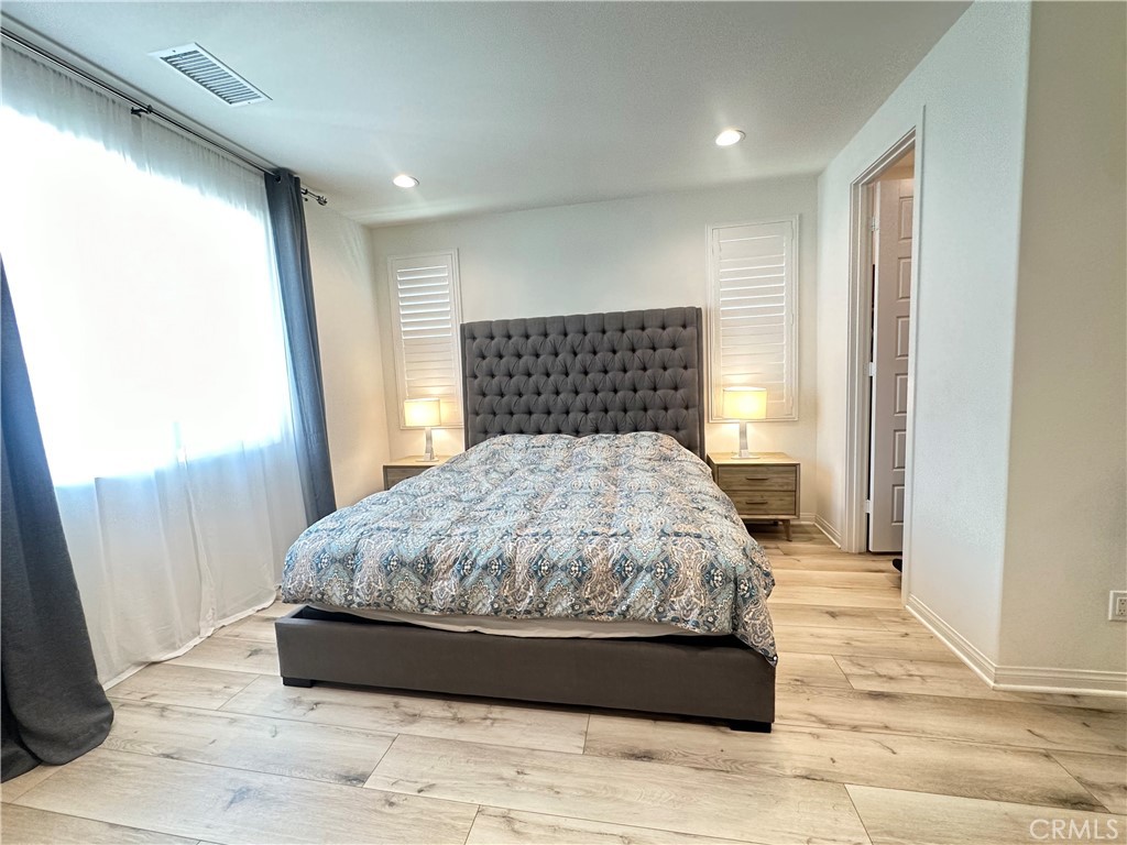 35 Hideaway Loop Mission Viejo, CA 92692 - Photo 10 of 24 a large bed sitting in a bedroom next to a window