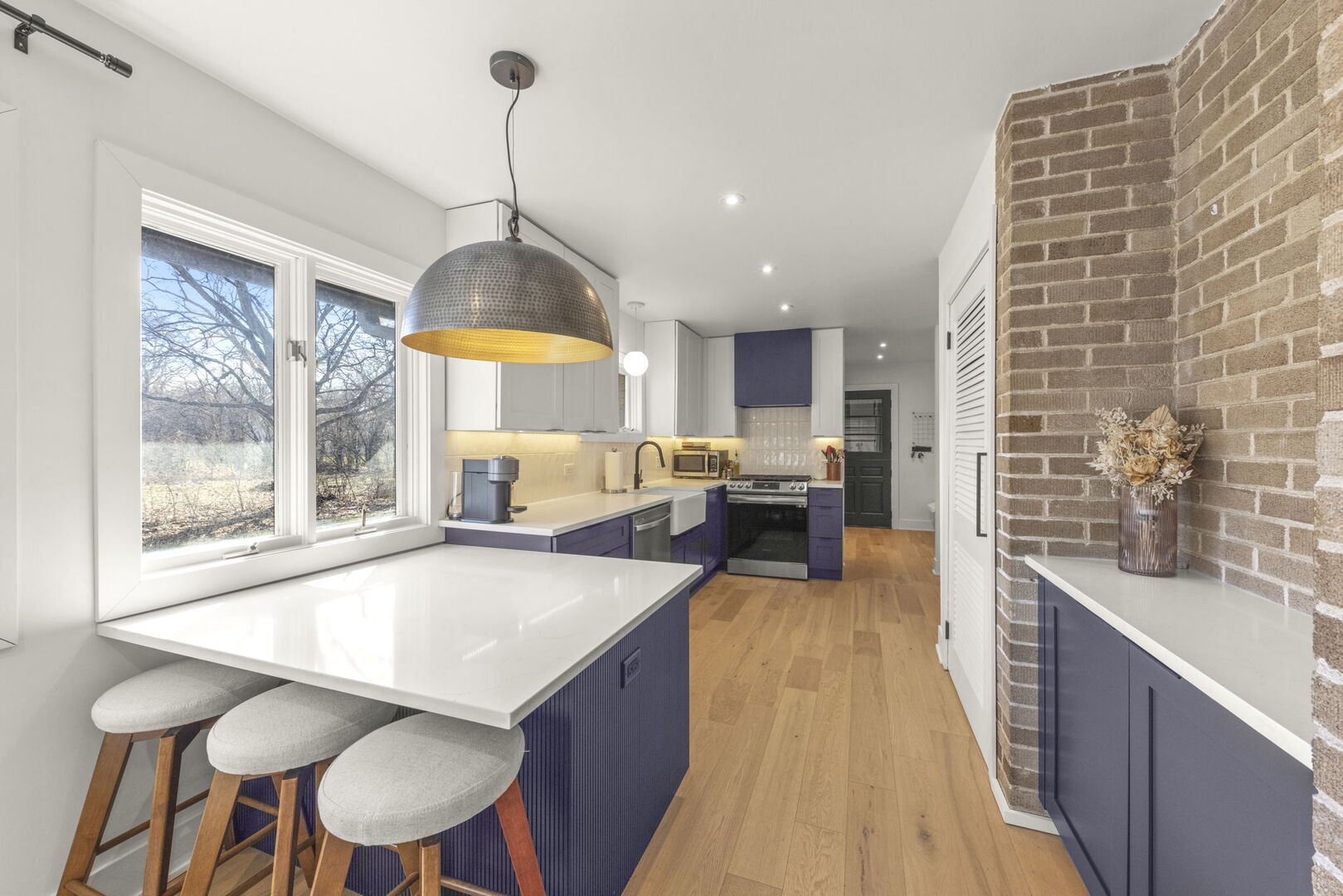 1100 South Westmore-Meyers Road Lombard, IL 60148 - Photo 5 of 28 a kitchen with stainless steel appliances granite countertop a kitchen island a stove a table and chairs in it