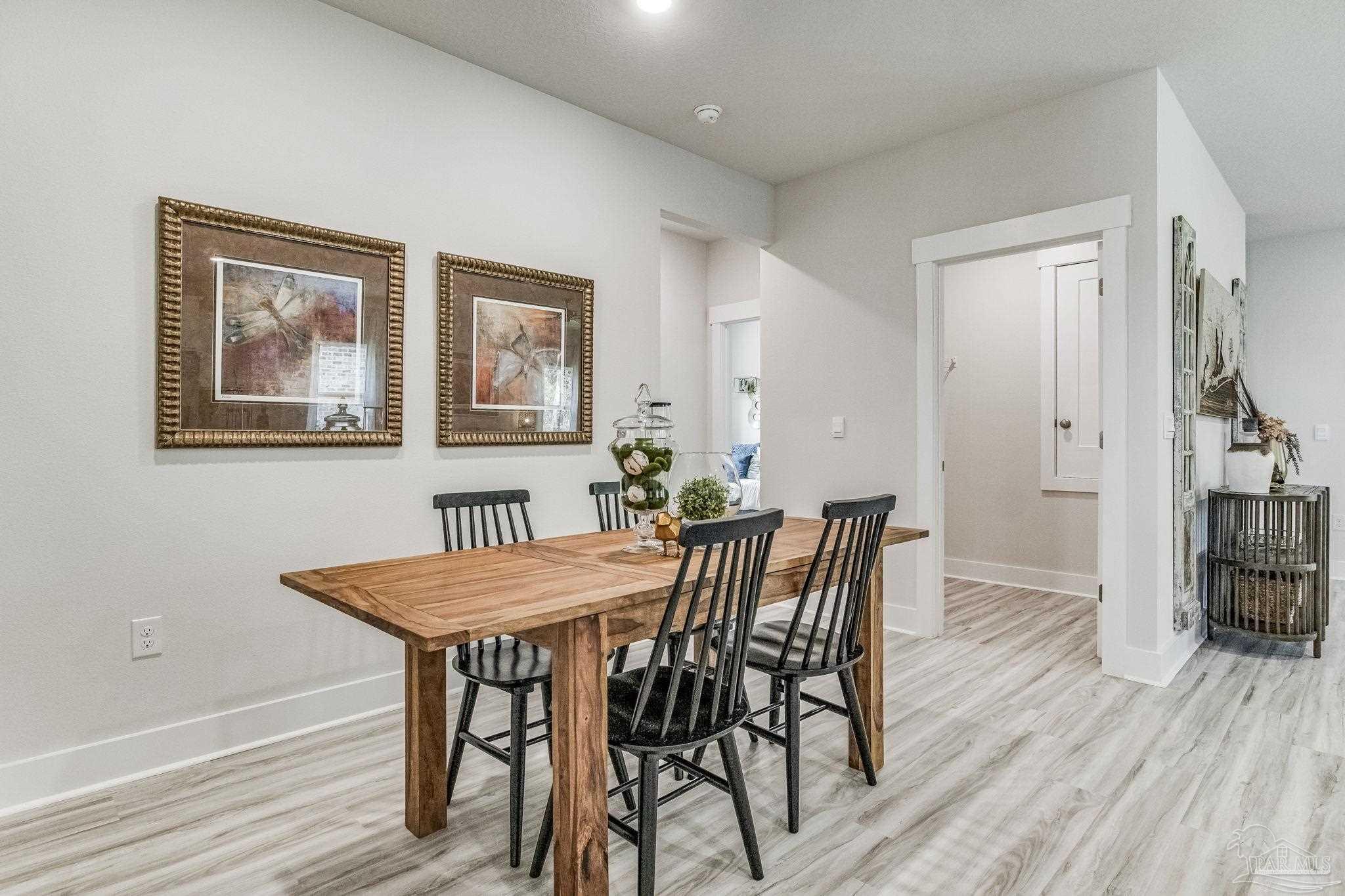 3861 Eagle Tail Drive Jay, FL 32565 - Photo 4 of 20 a view of a dining room with furniture and wooden floor