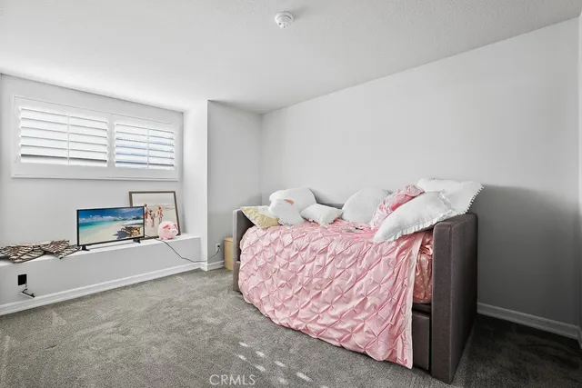 a bed room with a bed and a chair