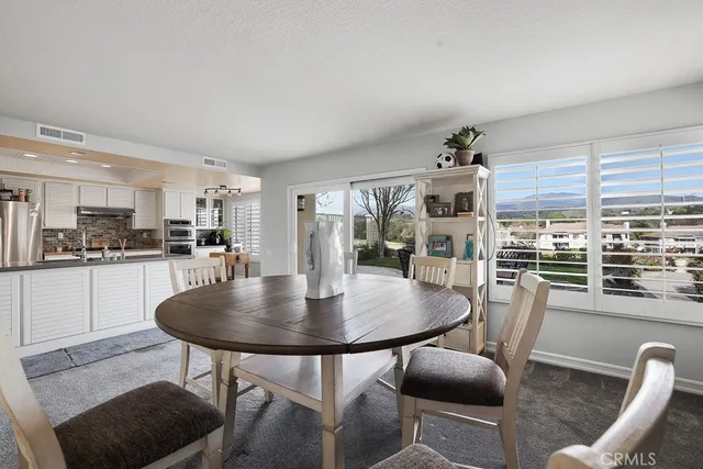 a dining room with furniture and wooden floor