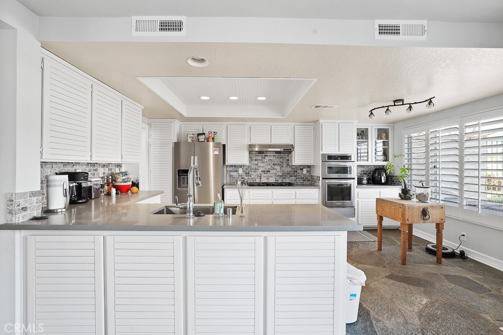 58 Via Candelaria Coto de Caza, CA 92679 - Photo 8 of 17 a kitchen with stainless steel appliances kitchen island granite countertop a refrigerator and cabinets