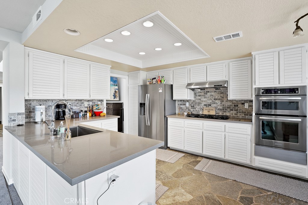 58 Via Candelaria Coto de Caza, CA 92679 - Photo 9 of 17 a kitchen with stainless steel appliances granite countertop a kitchen island a stove and a sink