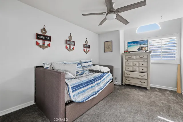 a living room with furniture and a dresser