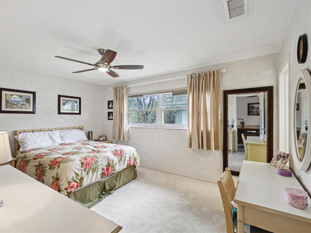 1433 South Belcher Road, Unit F20 Clearwater, FL 33764 - Photo 14 of 57 a bedroom with a bed and a table