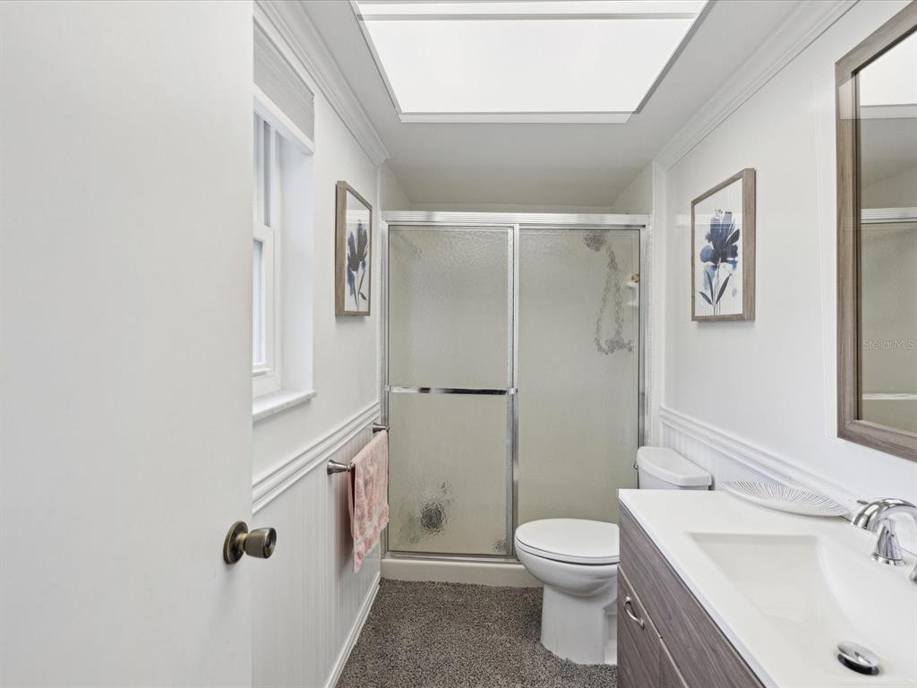 1433 South Belcher Road, Unit F20 Clearwater, FL 33764 - Photo 18 of 57 a bathroom with a sink a toilet and shower