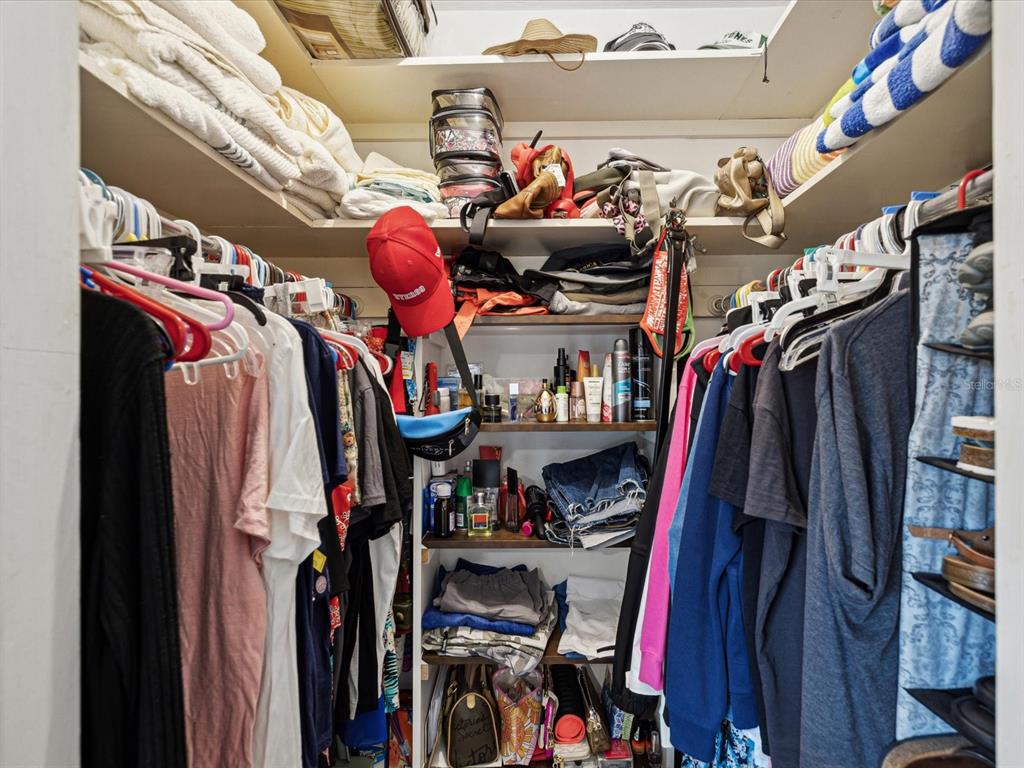 1433 South Belcher Road, Unit F20 Clearwater, FL 33764 - Photo 19 of 57 a view of walk in closet with clothes and shoes