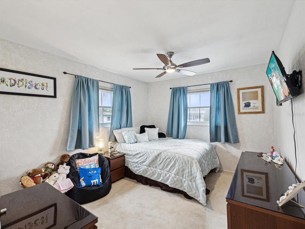 1433 South Belcher Road, Unit F20 Clearwater, FL 33764 - Photo 20 of 57 a bedroom with a bed and wooden floor