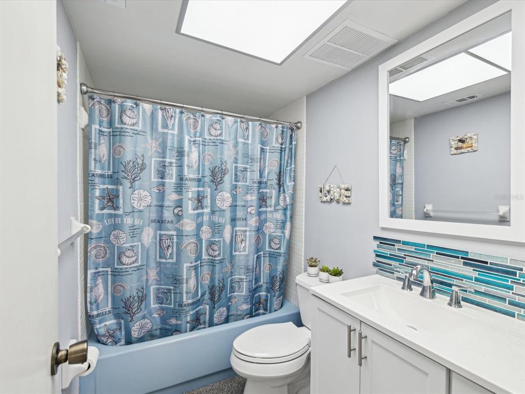 1433 South Belcher Road, Unit F20 Clearwater, FL 33764 - Photo 23 of 57 a bathroom with a sink a toilet and shower