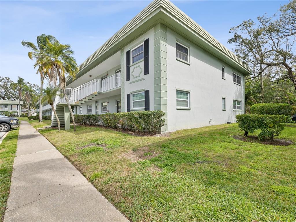 1433 South Belcher Road, Unit F20 Clearwater, FL 33764 - Photo 31 of 57 a front view of a house with garden