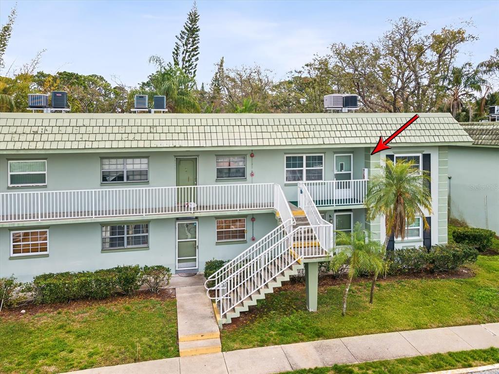 1433 South Belcher Road, Unit F20 Clearwater, FL 33764 - Photo 33 of 57 a front view of a house with a garden