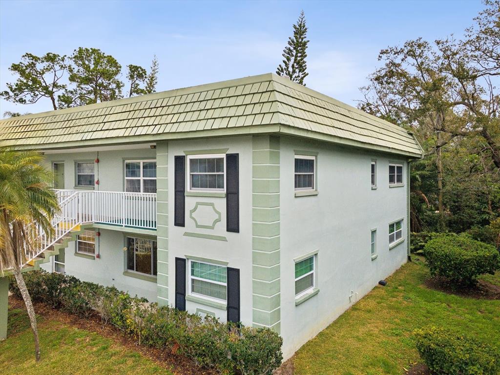 1433 South Belcher Road, Unit F20 Clearwater, FL 33764 - Photo 34 of 57 a front view of a house with a yard