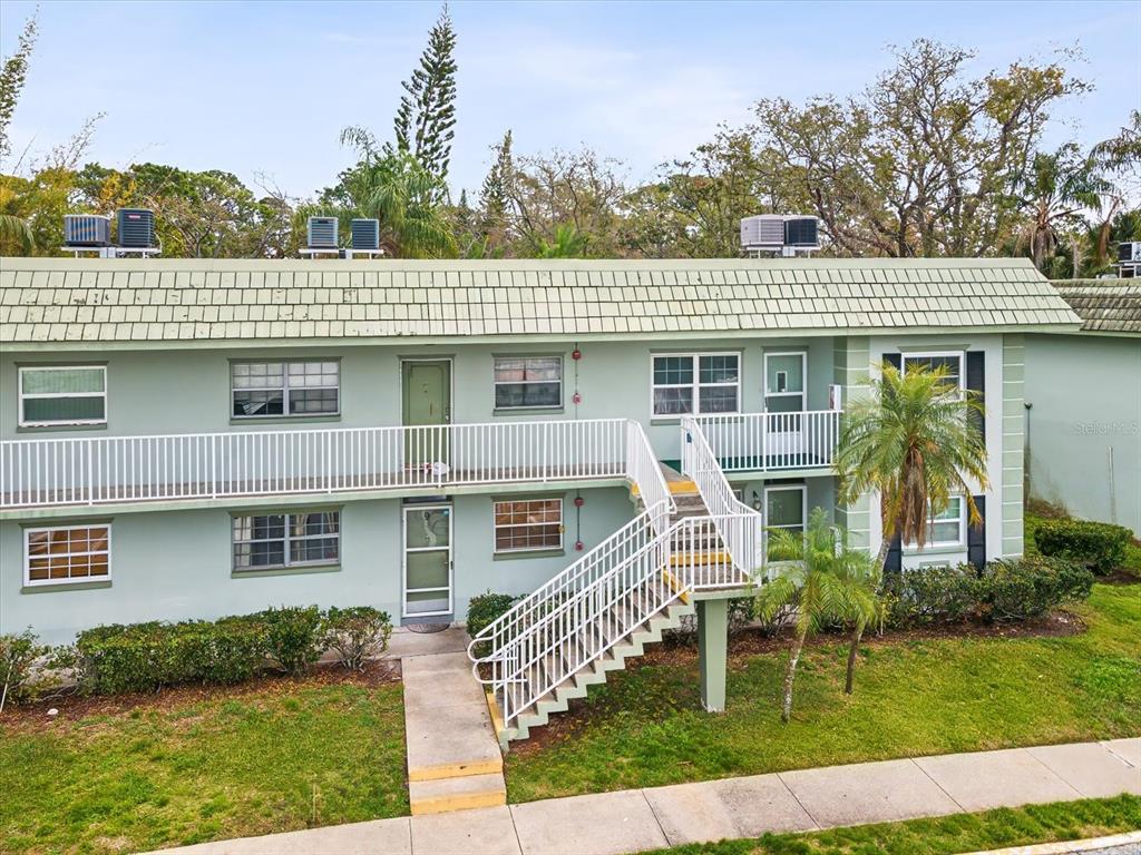 1433 South Belcher Road, Unit F20 Clearwater, FL 33764 - Photo 35 of 57 a front view of a house with a garden