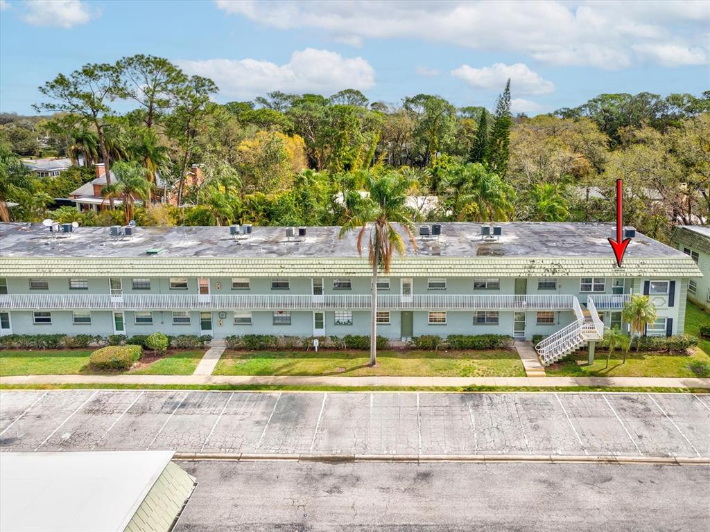 1433 South Belcher Road, Unit F20 Clearwater, FL 33764 - Photo 38 of 57 a view of a swimming pool with a lawn chairs