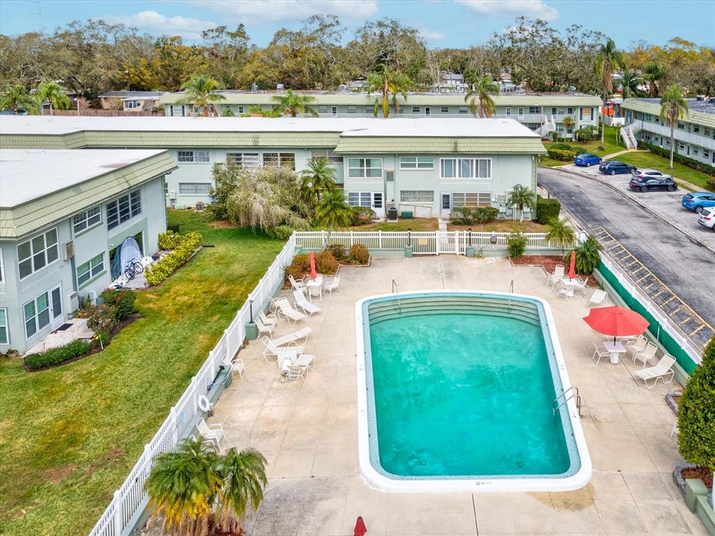 1433 South Belcher Road, Unit F20 Clearwater, FL 33764 - Photo 42 of 57 an aerial view of a house with a garden and lake view
