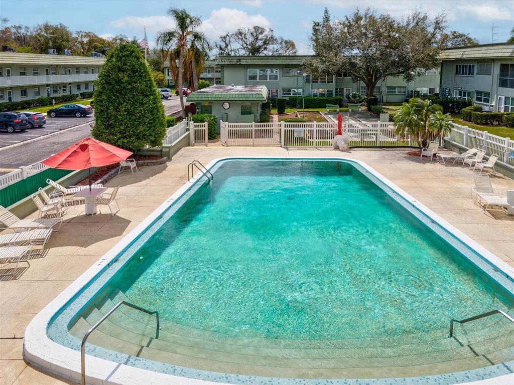 1433 South Belcher Road, Unit F20 Clearwater, FL 33764 - Photo 44 of 57 an outdoor space with swimming pool and furniture