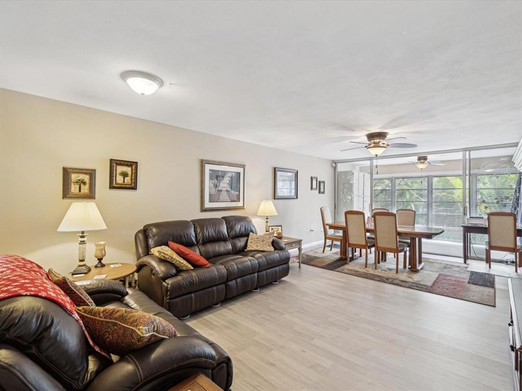 1433 South Belcher Road, Unit F20 Clearwater, FL 33764 - Photo 5 of 57 a living room with furniture and large windows