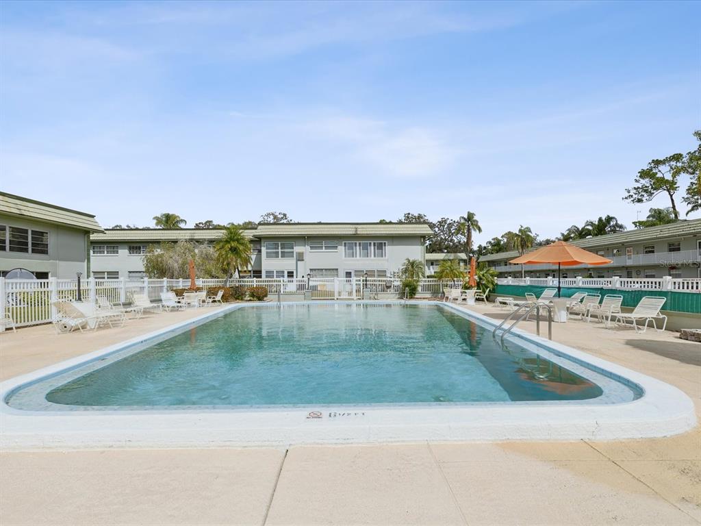 1433 South Belcher Road, Unit F20 Clearwater, FL 33764 - Photo 54 of 57 a view of a swimming pool from a balcony