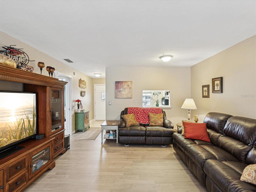 1433 South Belcher Road, Unit F20 Clearwater, FL 33764 - Photo 6 of 57 a living room with furniture and a flat screen tv