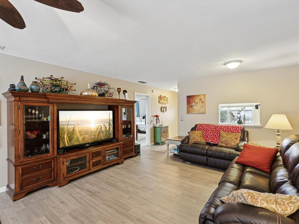 1433 South Belcher Road, Unit F20 Clearwater, FL 33764 - Photo 7 of 57 a living room with furniture and a flat screen tv