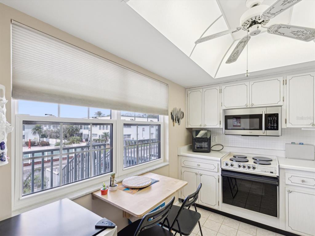1433 South Belcher Road, Unit F20 Clearwater, FL 33764 - Photo 10 of 57 a kitchen with a stove a sink and a microwave