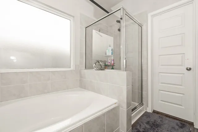 a bathroom with a bathtub and a shower