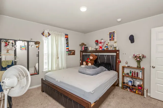 a bed room with a bed and a chair