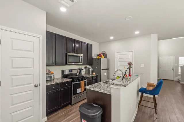 a kitchen with a refrigerator stove and microwave