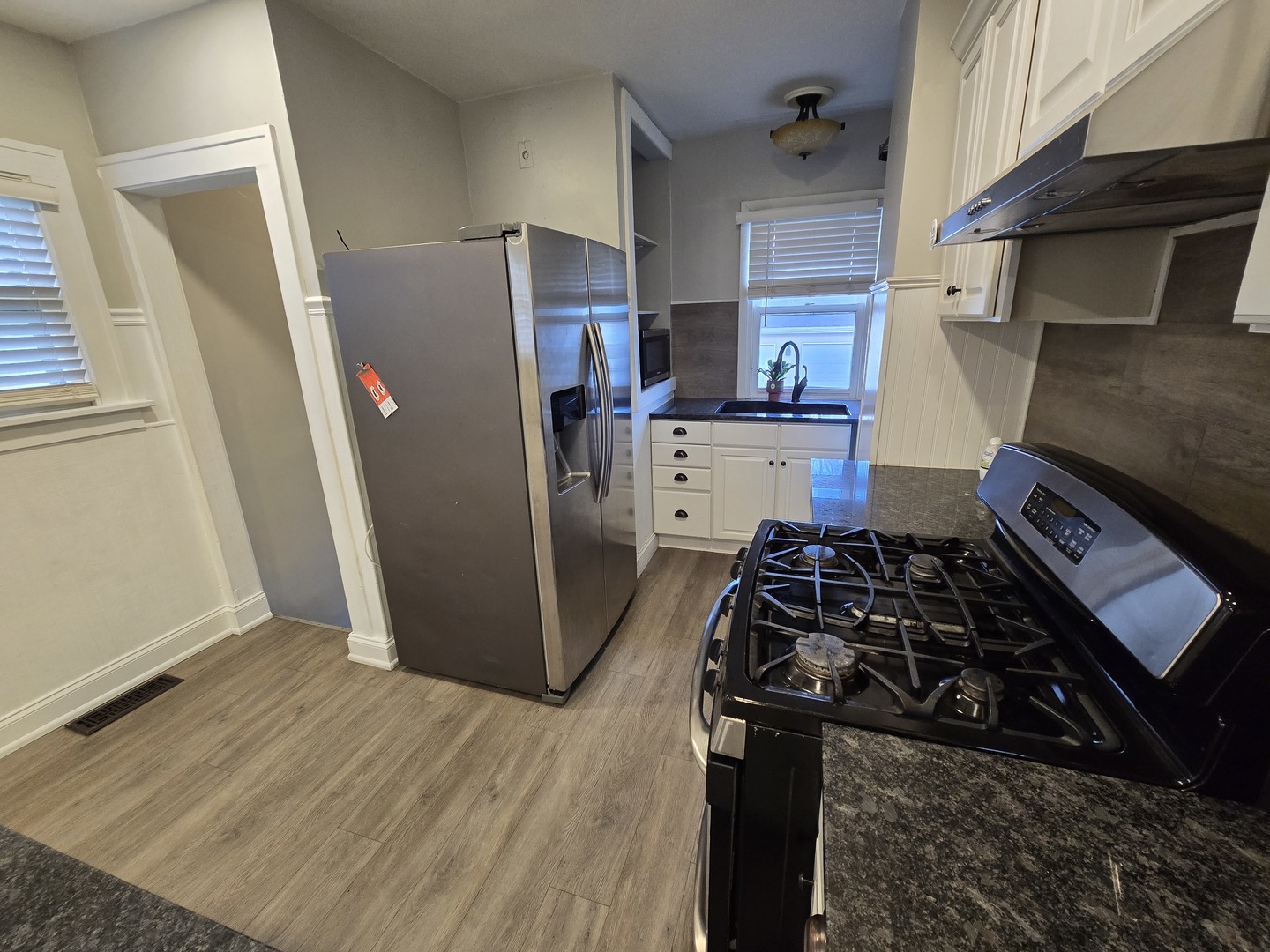 185 Pick Avenue Elmhurst, IL 60126 - Photo 8 of 24 a kitchen with a refrigerator stove and wooden floor
