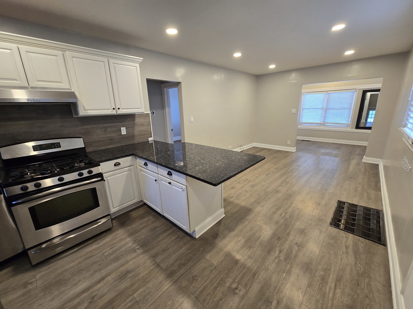 185 Pick Avenue Elmhurst, IL 60126 - Photo 9 of 24 a kitchen with stainless steel appliances kitchen island granite countertop a stove a sink and a refrigerator