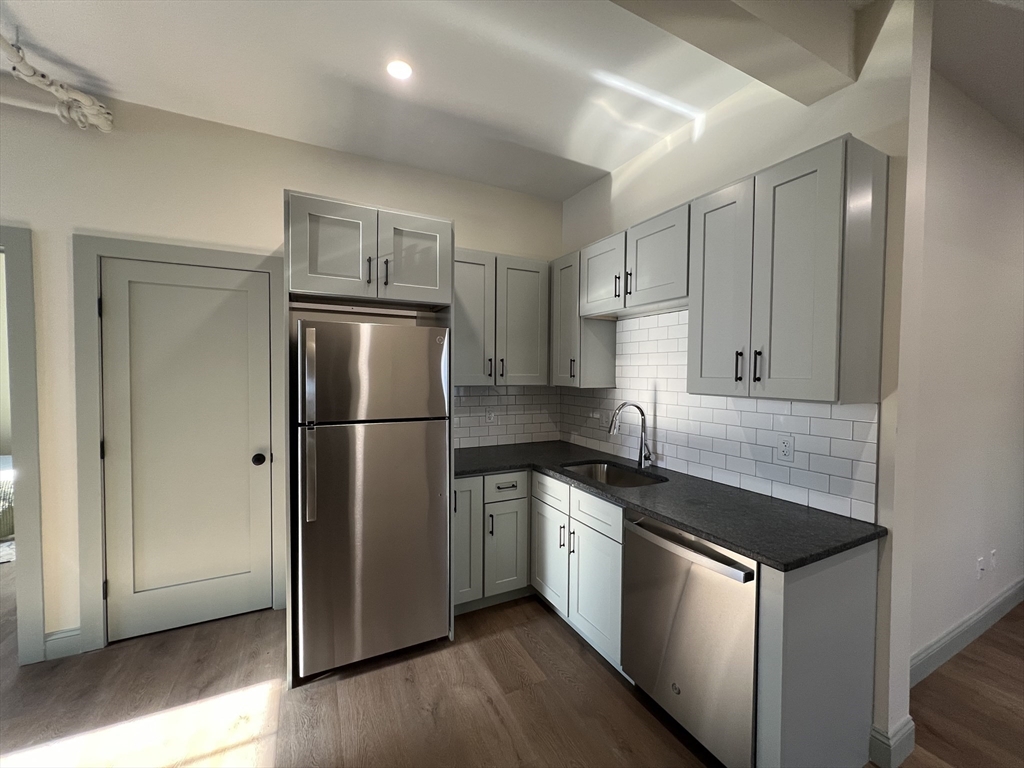 160 Seabury Street, Unit 9 Fall River, MA 02720 - Photo 1 of 14 a kitchen with stainless steel appliances granite countertop a refrigerator a sink and a stove
