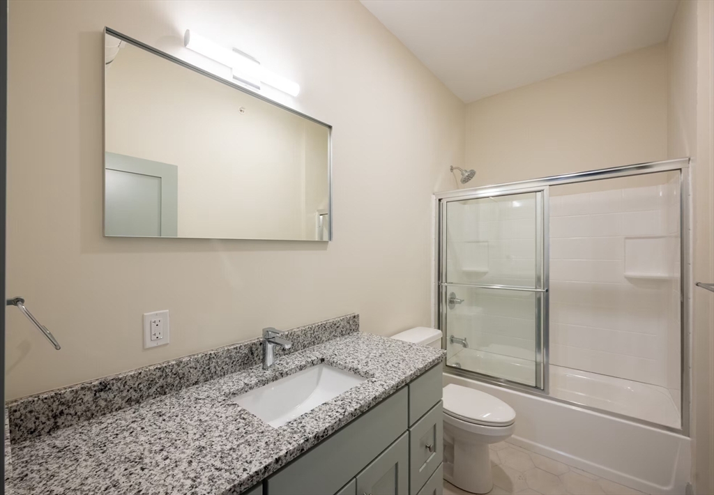 160 Seabury Street, Unit 9 Fall River, MA 02720 - Photo 11 of 14 a bathroom with a granite countertop sink toilet and shower