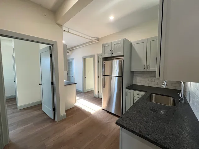 a kitchen with a refrigerator and a sink
