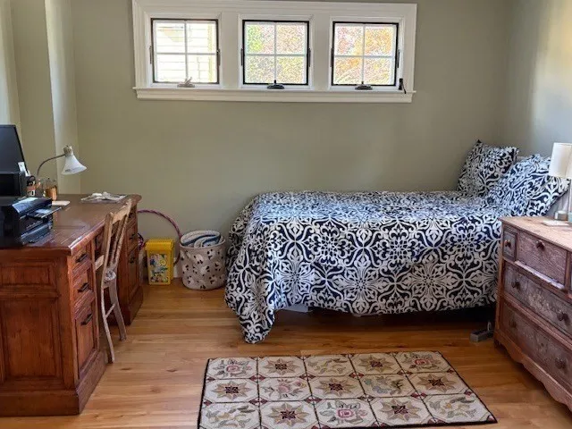 a bed sitting in a bedroom next to a window