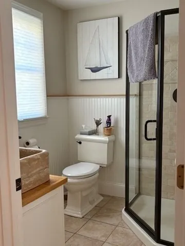 a bathroom with a toilet sink vanity and shower