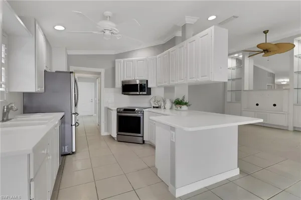a kitchen with a sink a stove and refrigerator