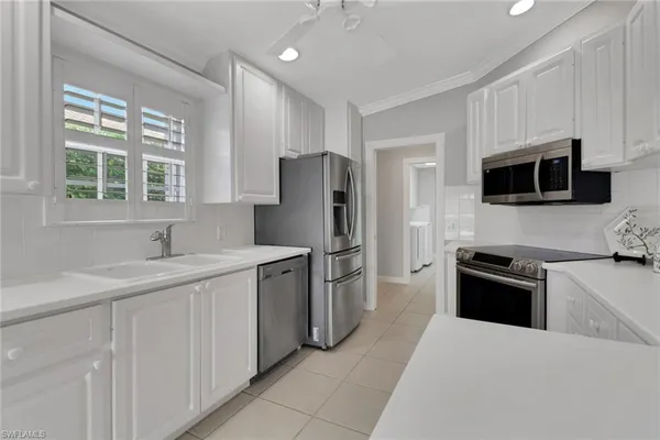 a kitchen with a sink stove and refrigerator