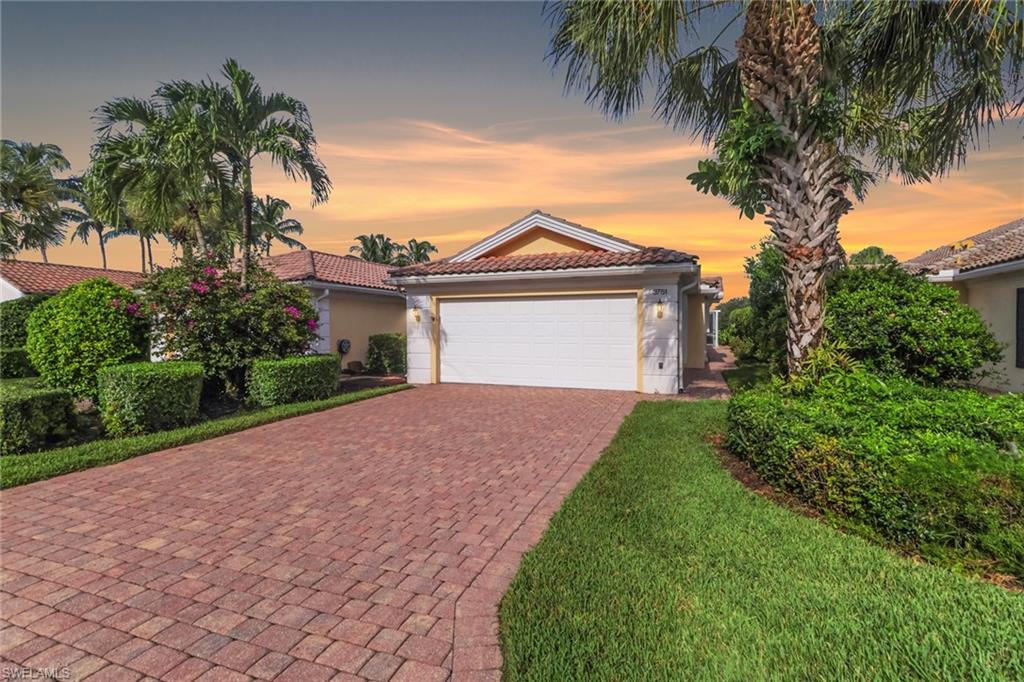 3751 Exuma Way Naples, FL 34119 - Photo 2 of 33 a front view of a house with a garden