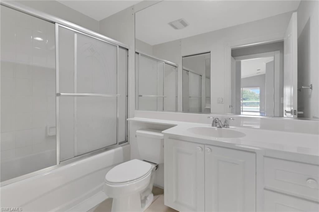 3751 Exuma Way Naples, FL 34119 - Photo 21 of 33 a bathroom with a granite countertop sink toilet and shower