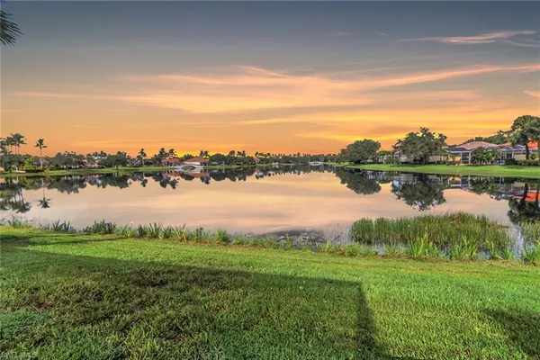 a view of a lake with houses in the back