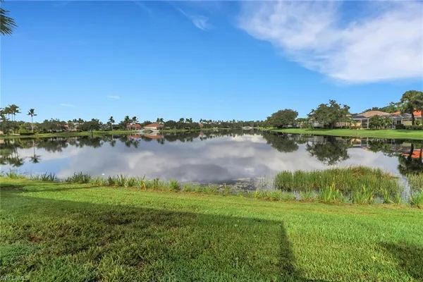 a view of a lake with houses in the back