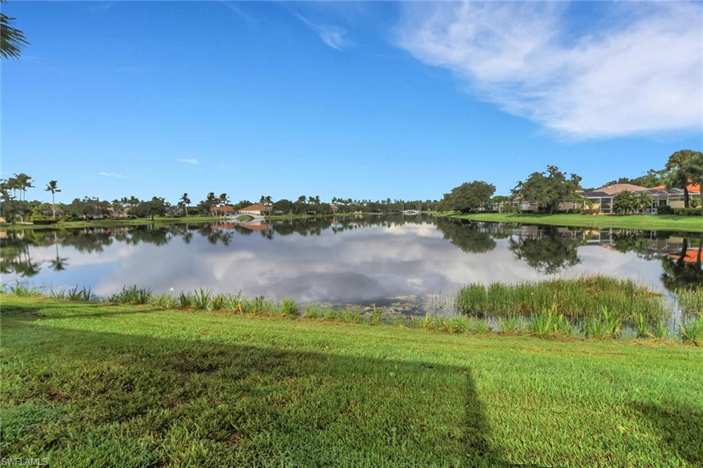 3751 Exuma Way Naples, FL 34119 - Photo 32 of 33 a view of a lake with houses in the back