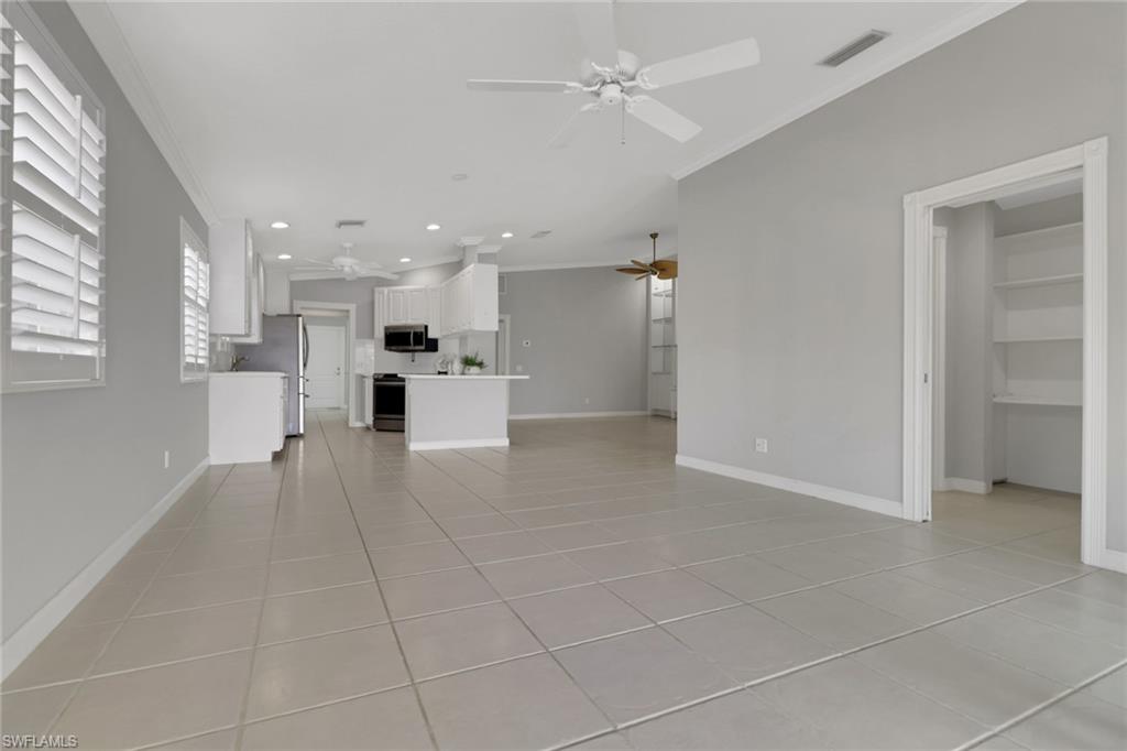 3751 Exuma Way Naples, FL 34119 - Photo 9 of 33 a view of an empty room and a kitchen