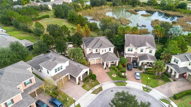 an aerial view of a house with garden space and lake view